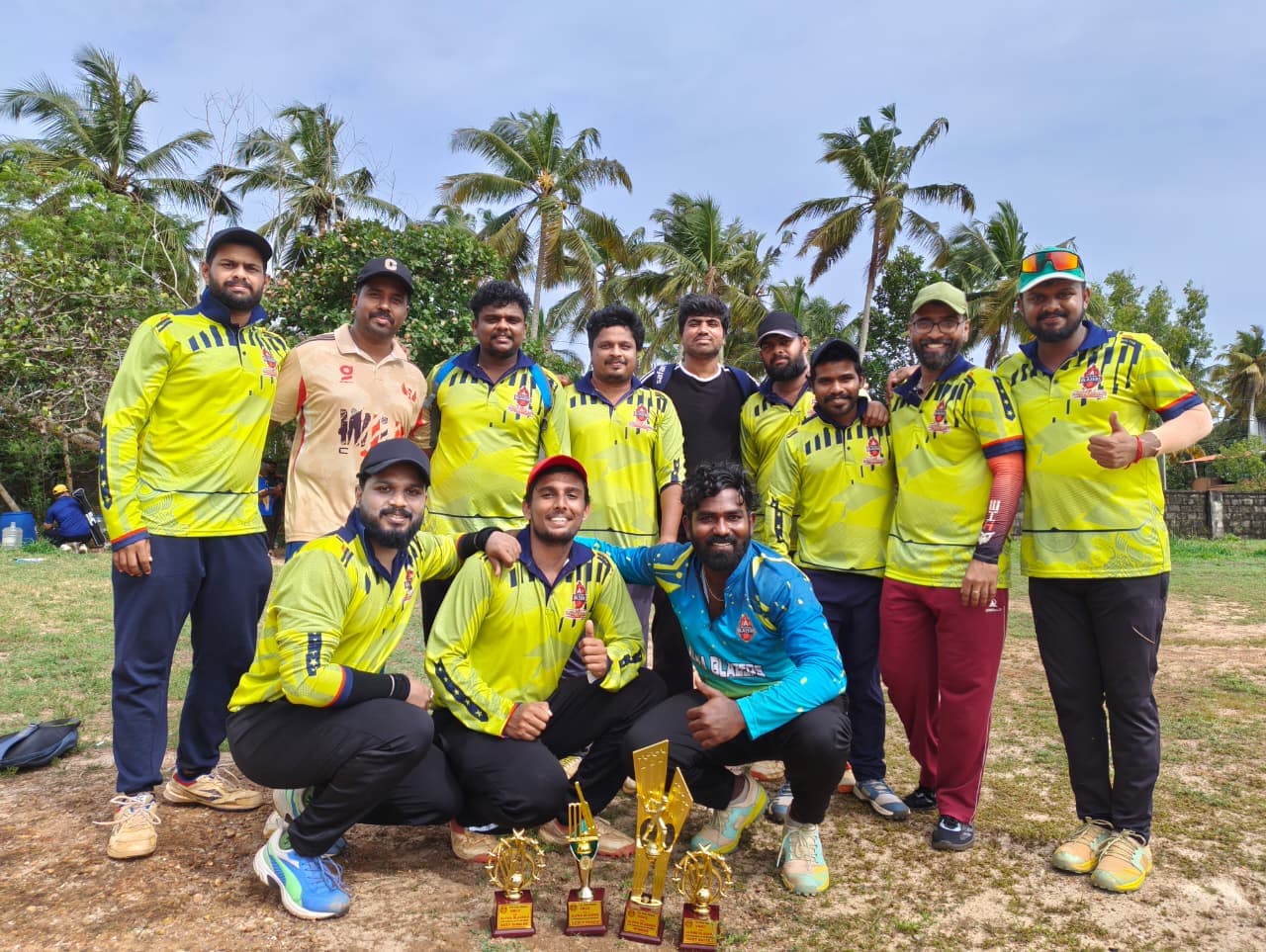 Adarsh with his cricket team and their trophies